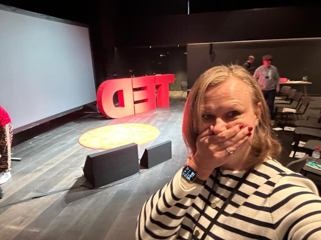 Karli taking a selfie on the TED stage