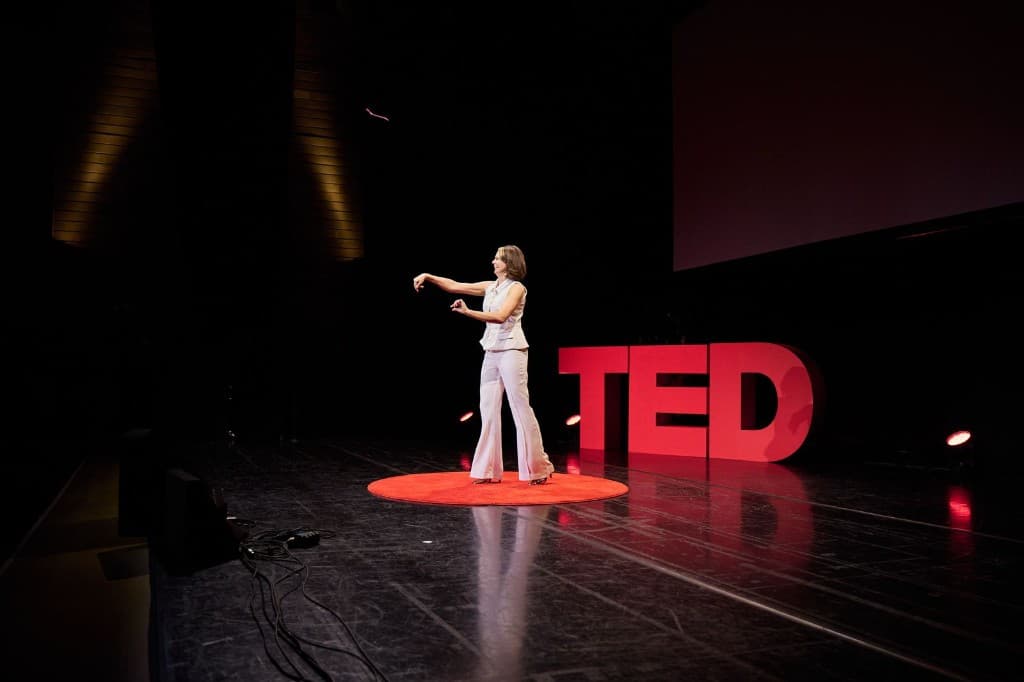 Karli delivering a TED talk on stage
