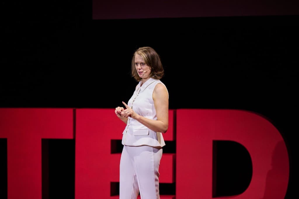 Karli speaking on stage at TED
